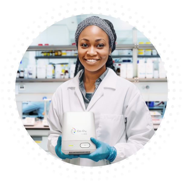 Woman in a lab coat holding the pcr pro box.